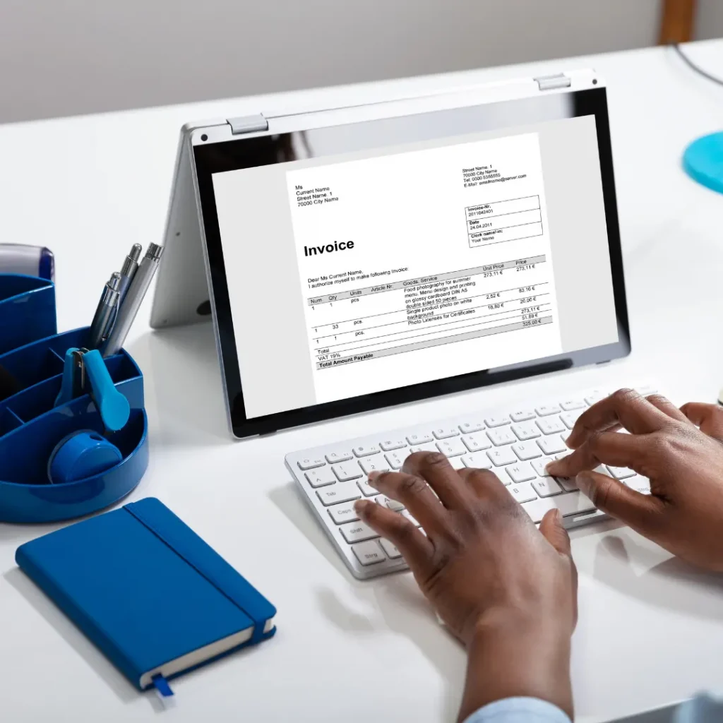 Woman typing on a tablet creating an invoice