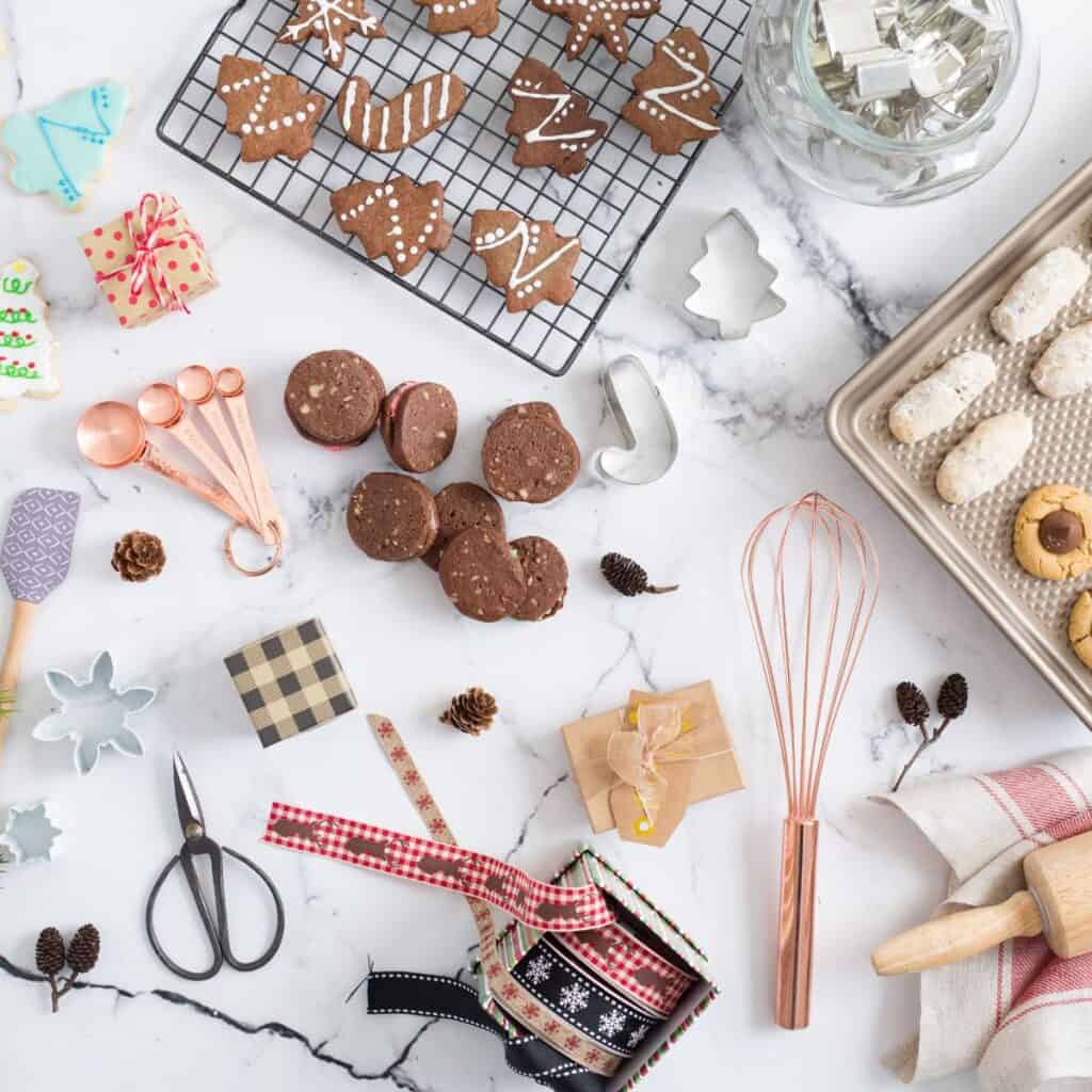 Holiday-themed tree cookies with a bunch of banking-related items on a white marble background