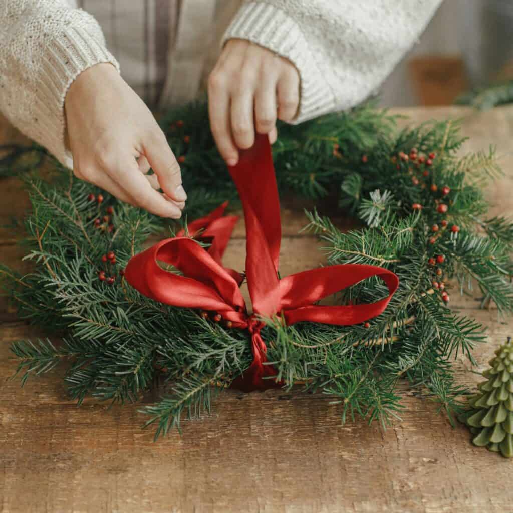 Tying a bow on a wreath
